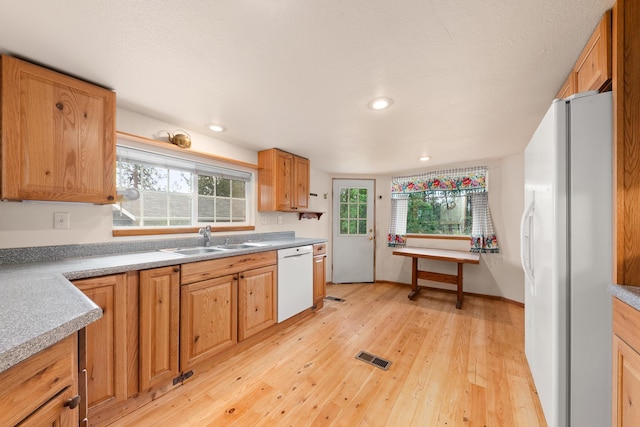6325 W 48th Ave, Spokane, WA 99224 - kitchen with white appliances, a sink, light wood-type flooring, healthy amount of natural light, and recessed lighting