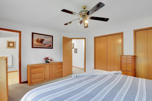 15711 N Unicorn Ct, Mead, WA 99021 - bedroom with light colored carpet, multiple closets, and a ceiling fan