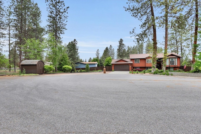 15711 N Unicorn Ct, Mead, WA 99021 - view of front of home featuring a garage, a shed, and driveway