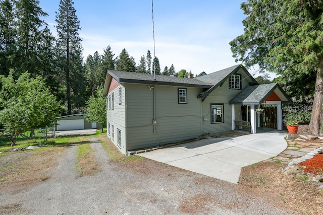 2526 E 8th Ave, Spokane, WA 99202 - back of property with driveway, a chimney, a shingled roof, and an outdoor structure