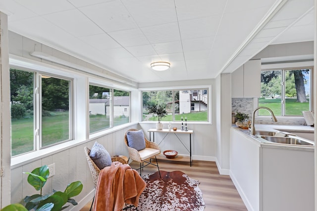 2526 E 8th Ave, Spokane, WA 99202 - sunroom featuring a sink, plenty of natural light, wood finished floors, and baseboards