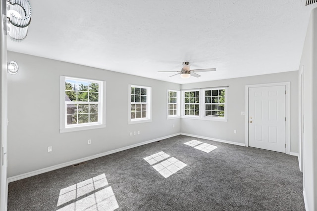 2526 E 8th Ave, Spokane, WA 99202 - carpeted empty room featuring healthy amount of natural light, ceiling fan, baseboards, and a textured ceiling