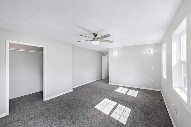 2526 E 8th Ave, Spokane, WA 99202 - unfurnished bedroom featuring dark carpet, a ceiling fan, baseboards, and a closet