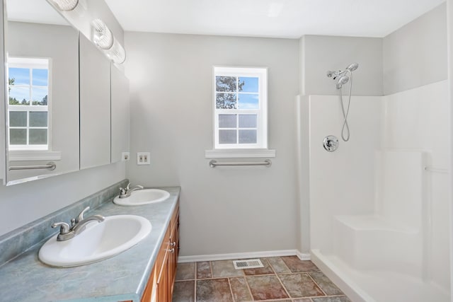 2526 E 8th Ave, Spokane, WA 99202 - full bathroom featuring plenty of natural light, double vanity, baseboards, and a shower