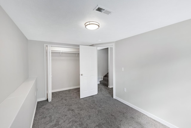 2526 E 8th Ave, Spokane, WA 99202 - unfurnished bedroom with dark colored carpet, baseboards, and a closet