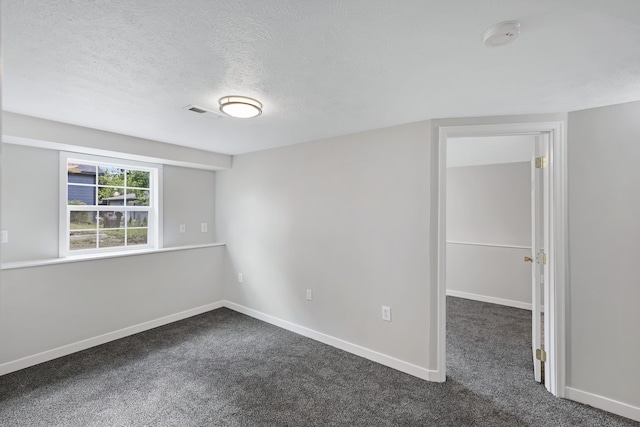 2526 E 8th Ave, Spokane, WA 99202 - unfurnished room with dark colored carpet, a textured ceiling, and baseboards