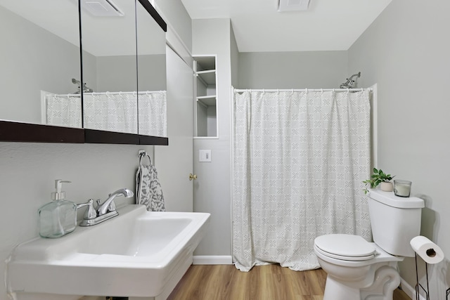 2526 E 8th Ave, Spokane, WA 99202 - bathroom featuring toilet, a sink, wood finished floors, and a shower with curtain