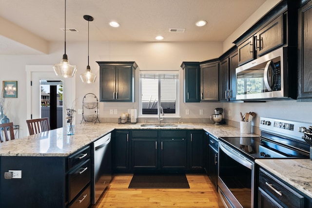 18218 E Michielli Ave, Spokane Valley, WA 99016 - kitchen featuring appliances with stainless steel finishes, a sink, a peninsula, healthy amount of natural light, and recessed lighting