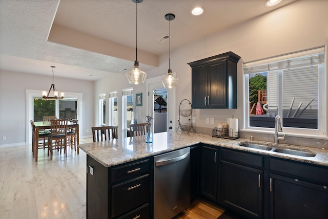 18218 E Michielli Ave, Spokane Valley, WA 99016 - kitchen with a sink, stainless steel dishwasher, a peninsula, light wood-type flooring, and light stone counters