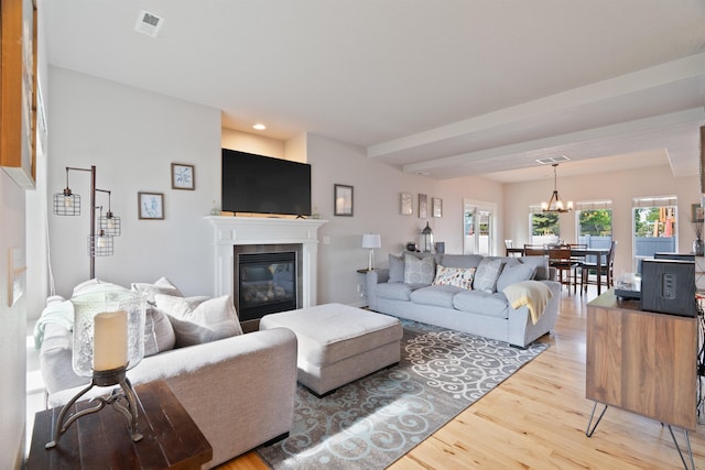 18218 E Michielli Ave, Spokane Valley, WA 99016 - living area with light wood-style flooring, a glass covered fireplace, a chandelier, and recessed lighting