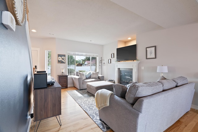 18218 E Michielli Ave, Spokane Valley, WA 99016 - living room with light wood-style flooring, a glass covered fireplace, and recessed lighting