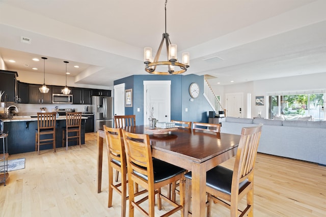 18218 E Michielli Ave, Spokane Valley, WA 99016 - dining space with a chandelier, light wood-type flooring, recessed lighting, a tray ceiling, and stairway