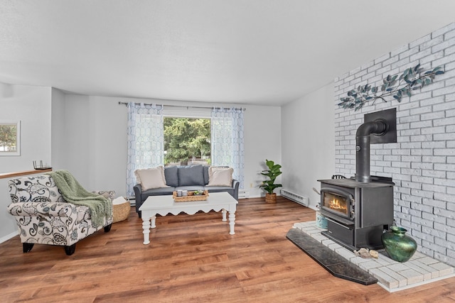 122 E Circle Dr, Newport, WA 99156 - sitting room featuring a baseboard heating unit, healthy amount of natural light, wood finished floors, and brick wall