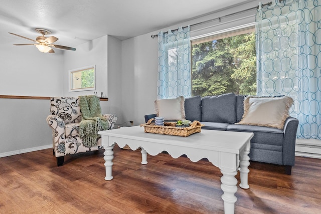 122 E Circle Dr, Newport, WA 99156 - living area with wood finished floors, ceiling fan, baseboards, and a baseboard radiator