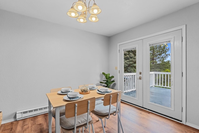 122 E Circle Dr, Newport, WA 99156 - dining space with a baseboard radiator, french doors, a chandelier, and wood finished floors