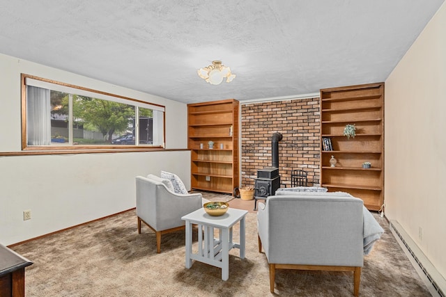 122 E Circle Dr, Newport, WA 99156 - carpeted living room featuring a baseboard heating unit, a wood stove, a textured ceiling, baseboards, and built in shelves