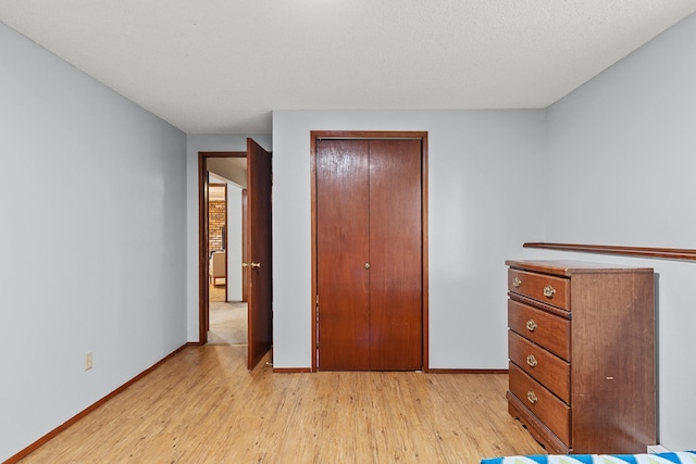 122 E Circle Dr, Newport, WA 99156 - bedroom featuring light wood-type flooring, baseboards, and a closet
