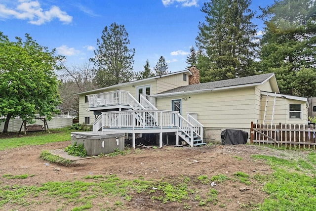 122 E Circle Dr, Newport, WA 99156 - back of property with a hot tub, stairs, a wooden deck, and a chimney