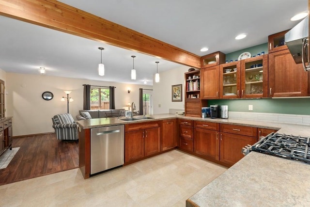 536 E 1st Ave, Colville, WA 99114 - kitchen featuring stainless steel dishwasher, a sink, a peninsula, beam ceiling, and brown cabinets