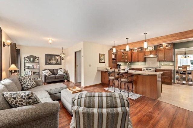536 E 1st Ave, Colville, WA 99114 - living area with light wood finished floors, baseboards, and a chandelier