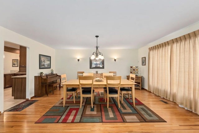 536 E 1st Ave, Colville, WA 99114 - dining space with light wood-style floors and a chandelier