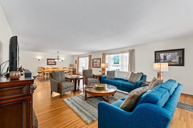 536 E 1st Ave, Colville, WA 99114 - living room featuring light wood-style floors and a chandelier