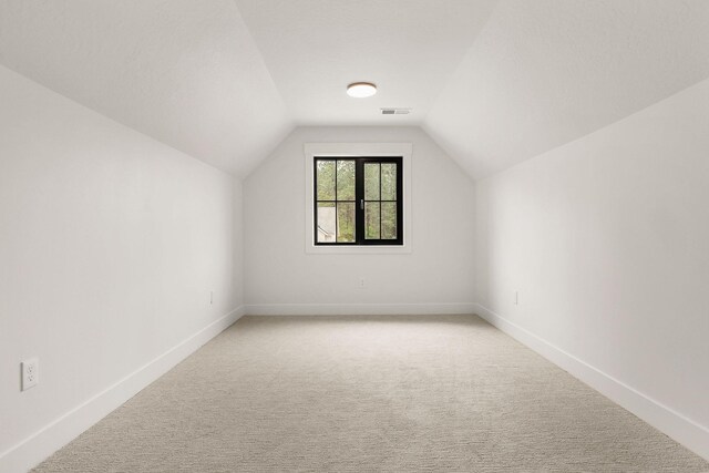 11711 E Honeycomb Springs Ln, Spokane, WA 99206 - bonus room with light carpet, vaulted ceiling, and baseboards