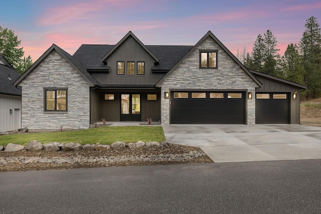 11711 E Honeycomb Springs Ln, Spokane, WA 99206 - modern farmhouse style home featuring stone siding, board and batten siding, driveway, and a standing seam roof