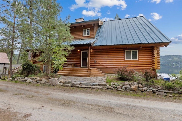 3947 N Deer Lake Rd, Loon Lake, WA 99148 - cabin with log siding, metal roof, and a chimney