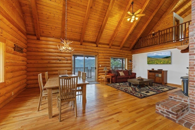 3947 N Deer Lake Rd, Loon Lake, WA 99148 - dining space with wood ceiling with exposed beams, a chandelier, high vaulted ceiling, light wood-style flooring, and a wood stove