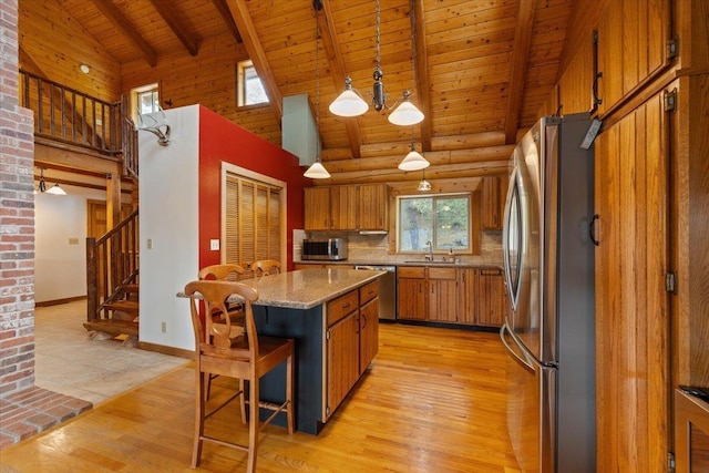 3947 N Deer Lake Rd, Loon Lake, WA 99148 - kitchen with appliances with stainless steel finishes, wood ceiling with exposed beams, brown cabinets, light wood finished floors, and high vaulted ceiling