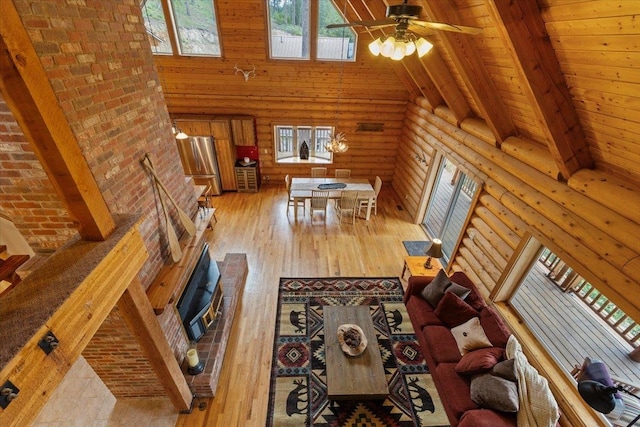 3947 N Deer Lake Rd, Loon Lake, WA 99148 - living room with log walls, high vaulted ceiling, a ceiling fan, hardwood / wood-style floors, and wooden ceiling with exposed beams