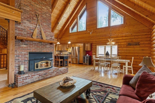 3947 N Deer Lake Rd, Loon Lake, WA 99148 - living room with high vaulted ceiling, wood ceiling with exposed beams, a chandelier, light wood-type flooring, and a fireplace