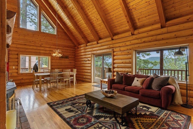 3947 N Deer Lake Rd, Loon Lake, WA 99148 - living room featuring high vaulted ceiling, wood ceiling with exposed beams, healthy amount of natural light, light wood-style flooring, and log walls