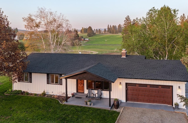 10409 E Palouse Hwy, Valleyford, WA 99036 - view of front of home featuring a shingled roof, a garage, and a front yard