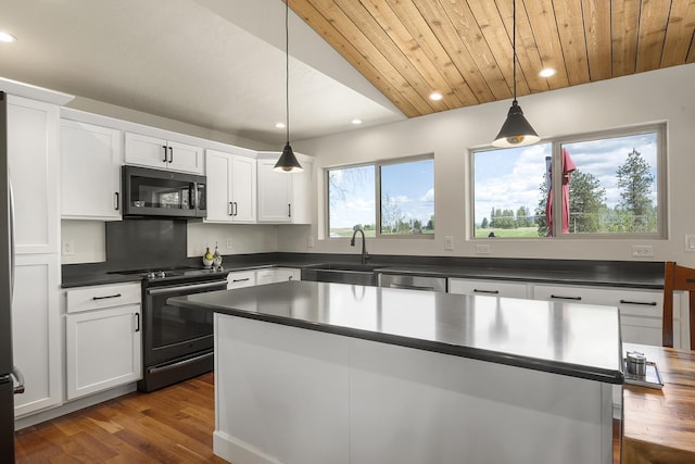 10409 E Palouse Hwy, Valleyford, WA 99036 - kitchen featuring stainless steel appliances, a sink, dark countertops, dark wood finished floors, and white cabinets