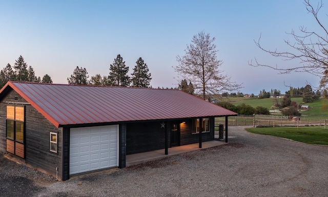 10409 E Palouse Hwy, Valleyford, WA 99036 - garage at dusk with a detached garage and gravel driveway