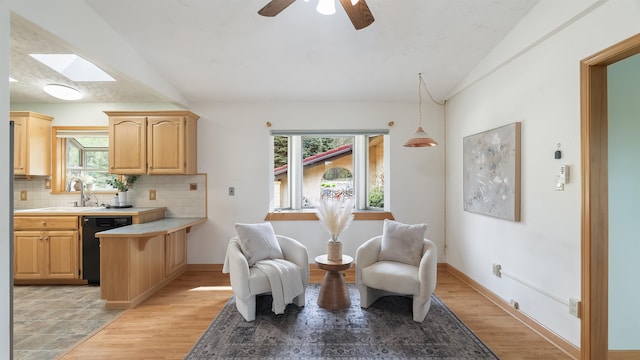 13110 W Charles Rd, Nine Mile Falls, WA 99026 - living area with healthy amount of natural light, a skylight, a ceiling fan, light wood-style floors, and vaulted ceiling