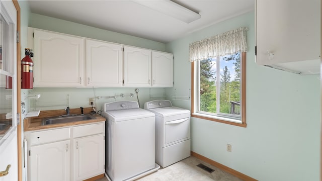 13110 W Charles Rd, Nine Mile Falls, WA 99026 - laundry area with cabinet space, washer and dryer, and baseboards