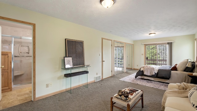 13110 W Charles Rd, Nine Mile Falls, WA 99026 - bedroom featuring access to outside, a textured ceiling, baseboards, light colored carpet, and connected bathroom