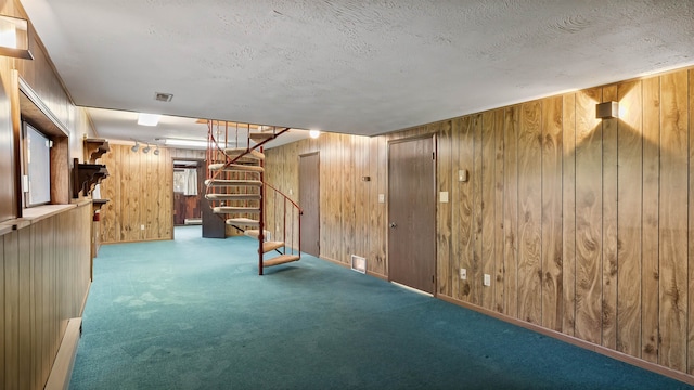 13110 W Charles Rd, Nine Mile Falls, WA 99026 - finished basement with wood walls, carpet, stairway, a textured ceiling, and baseboards