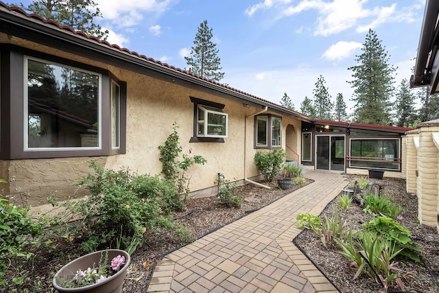 13110 W Charles Rd, Nine Mile Falls, WA 99026 - view of side of property with stucco siding, a patio area, and a tiled roof