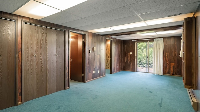 13110 W Charles Rd, Nine Mile Falls, WA 99026 - basement featuring wood walls, carpet floors, and a paneled ceiling