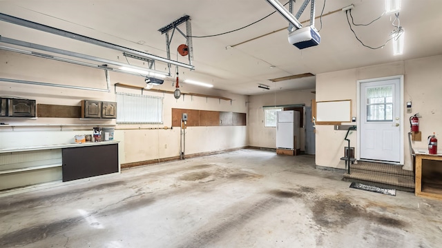 13110 W Charles Rd, Nine Mile Falls, WA 99026 - garage with freestanding refrigerator and a garage door opener