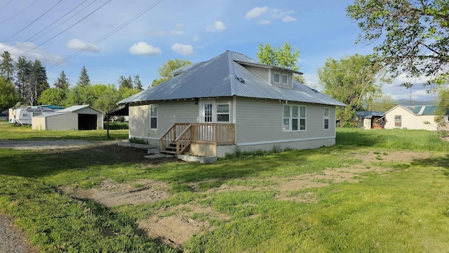 117 5th Ave, Cusick, WA 99119 - back of property with metal roof, an outdoor structure, and a lawn