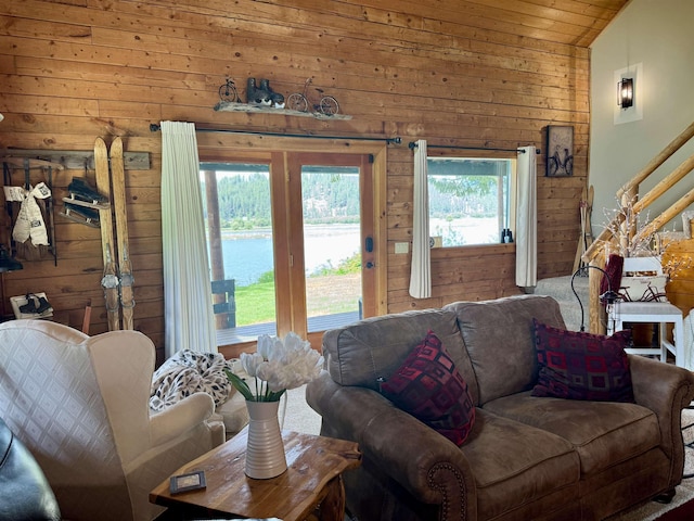 812 Levitch Rd, Newport, WA 99156 - living area featuring wood walls, carpet flooring, vaulted ceiling, and stairway