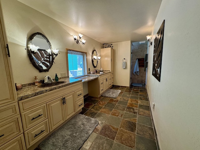 812 Levitch Rd, Newport, WA 99156 - bathroom with stone tile flooring, two vanities, and a tile shower