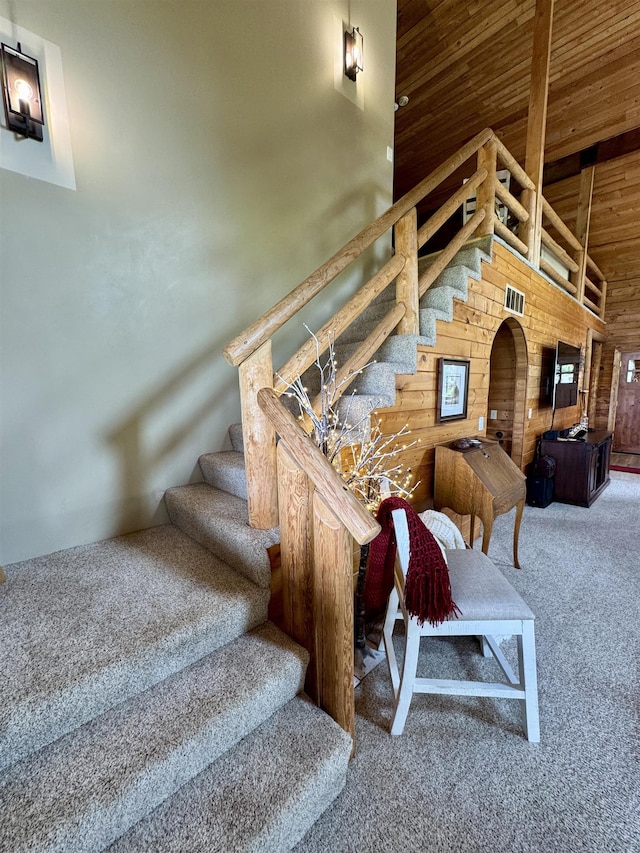 812 Levitch Rd, Newport, WA 99156 - stairway featuring carpet flooring, wooden ceiling, wood walls, and a high ceiling