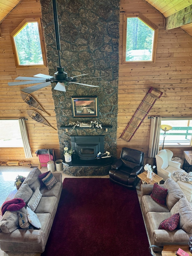 812 Levitch Rd, Newport, WA 99156 - living room featuring wooden walls, high vaulted ceiling, wooden ceiling, a ceiling fan, and a fireplace