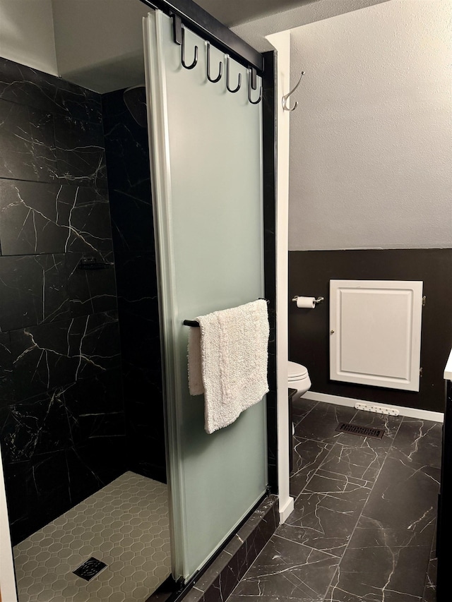 812 Levitch Rd, Newport, WA 99156 - full bath featuring marble look tiles, a marble finish shower, and toilet